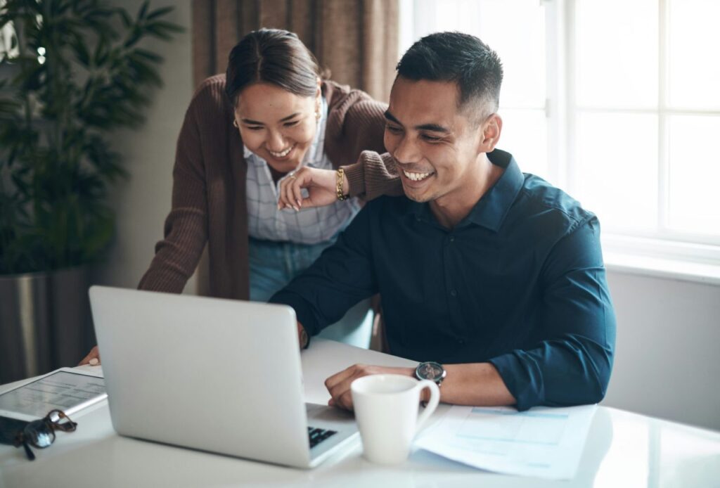 happy-with-how-their-finances-are-looking-shot-of-a-young-couple-using-a-laptop-together-at-home