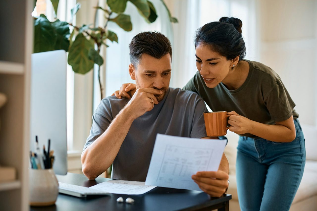 mid-adult-couple-analyzing-their-home-finances-at-home